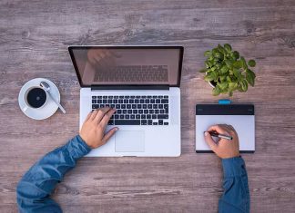 Apple ble një kompani të re çdo 2-3 javë Një djale me kompjuter mac ne tavoline dhe kafe duke shkruar ne nje magic trackpad